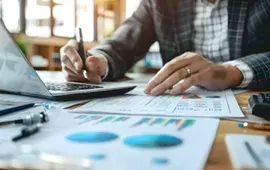 Man at Laptop with Charts and Graphs